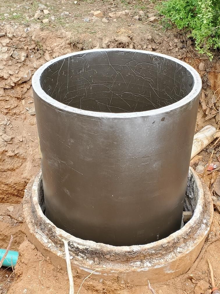 Polymer concrete rehabilitation insert being lowered into its concrete host structure