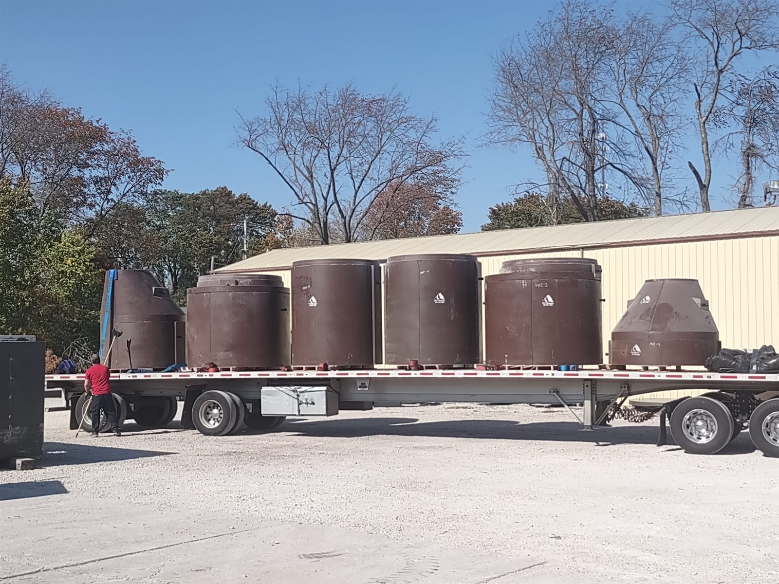 P3 manhole structures secured on a flatbed trailer