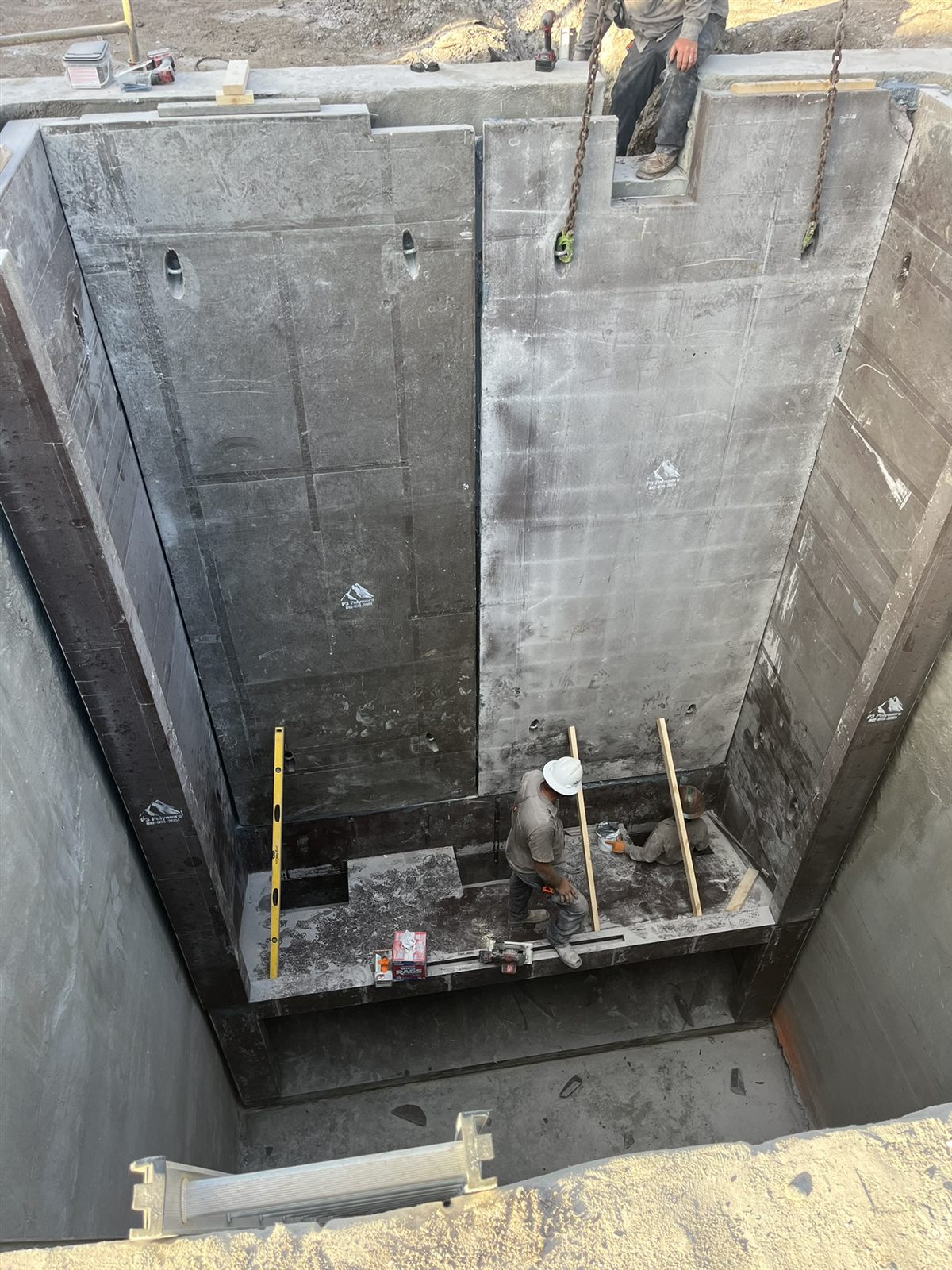 Crew assembling a large custom polymer concrete structure