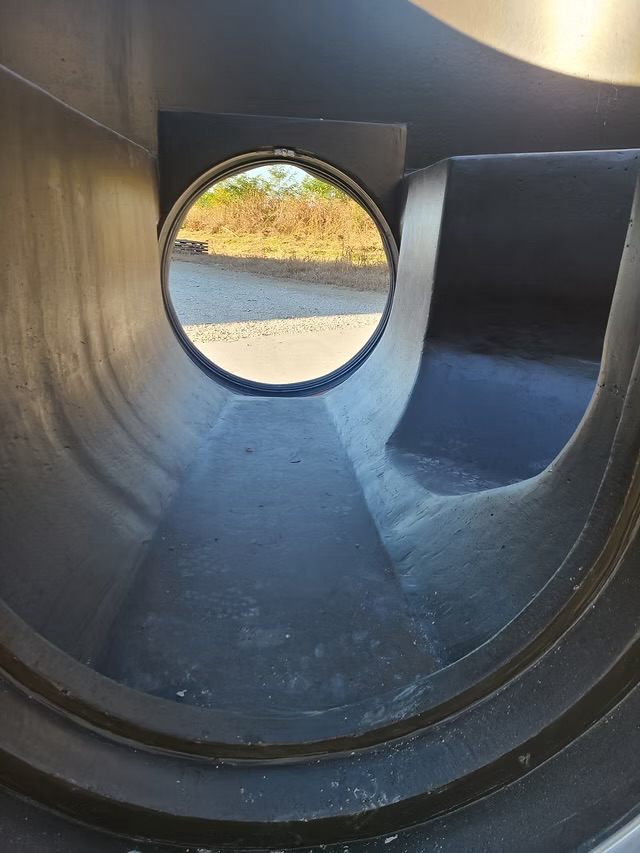 Interior bench and pipe opening in a P3 manhole