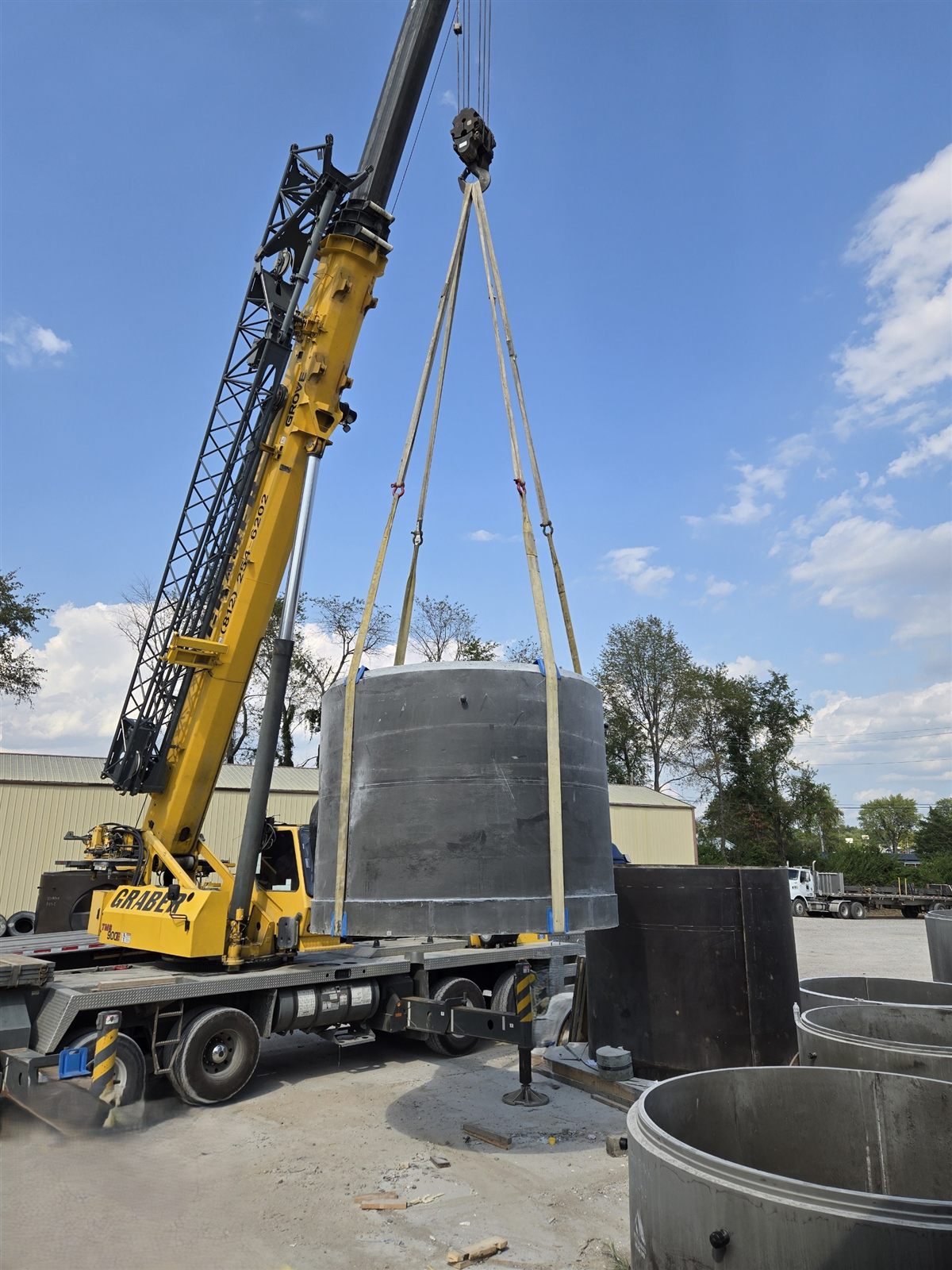 Crane lifting a P3 manhole section at the manufacturing facility