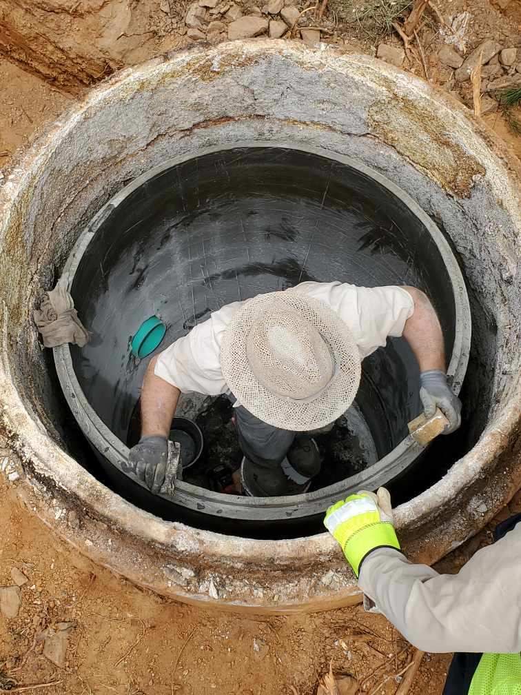 Crew working inside a polymer concrete insert during installation